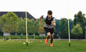 Young person running on a football pitch