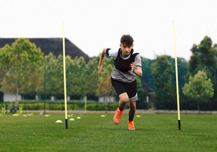 Young person running on a football pitch