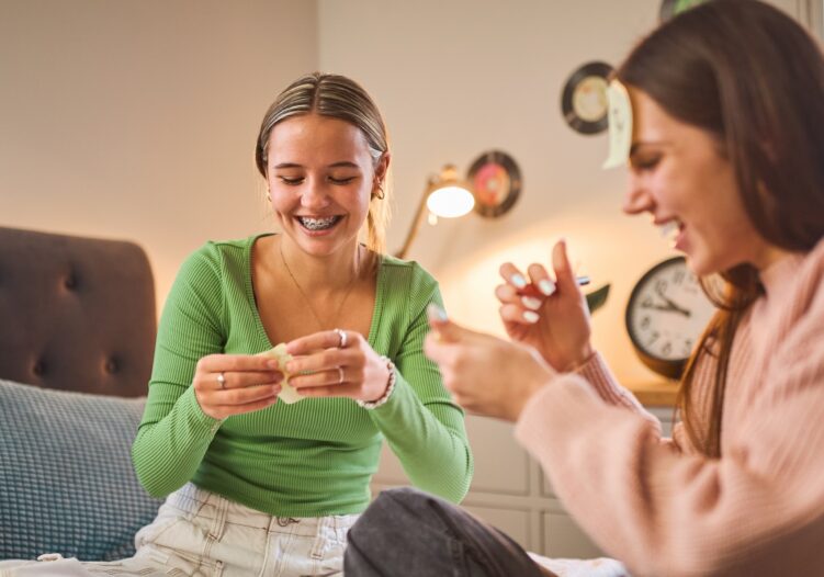 Two female friends playing a card game