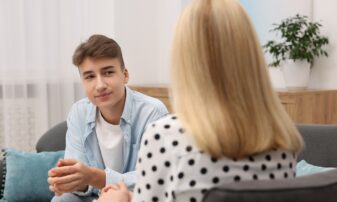 Teenage boy talking to support staff