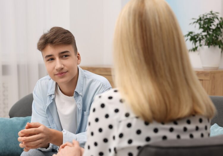 Teenage boy talking to support staff