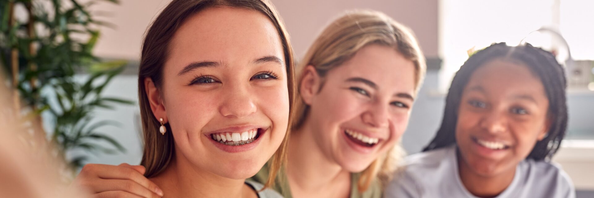 Group of teenage female friends laughing together