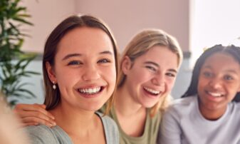 Group of teenage female friends laughing together